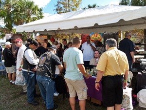 Cigar smokers gathering at one of the cigar vendor tents at the Tampa Cigar Fest